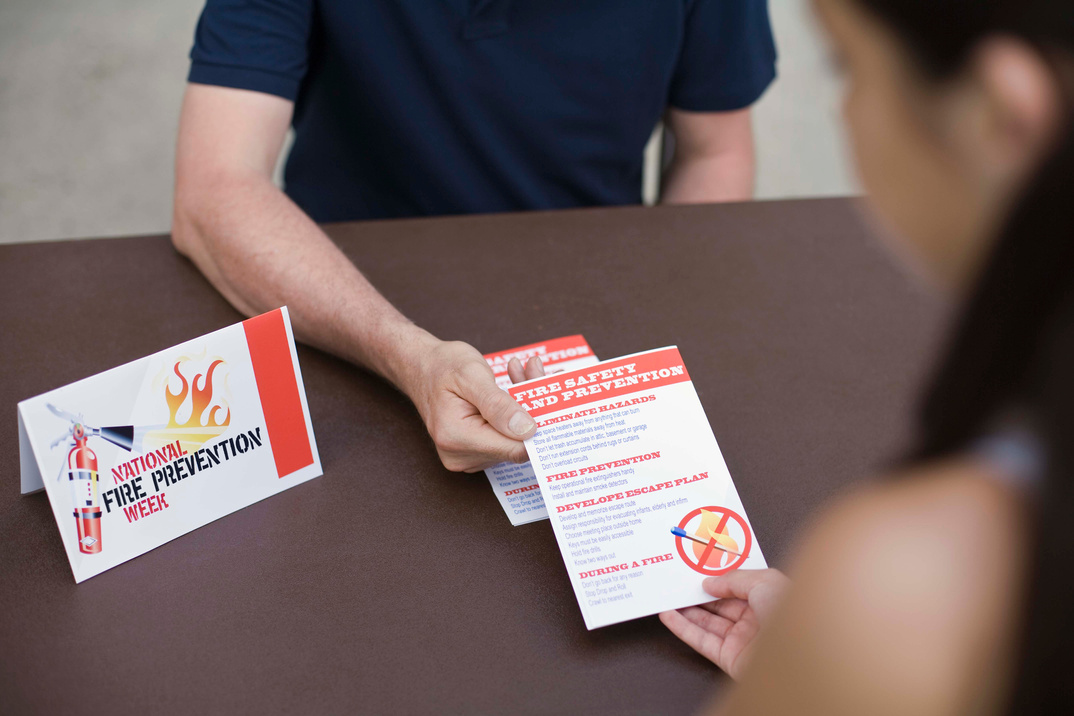 Man handing out fire prevention pamphlets